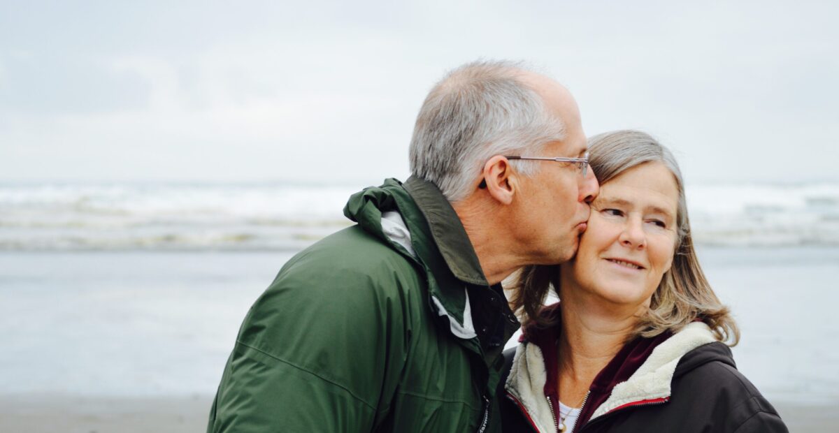 A man kissing a woman on the cheek